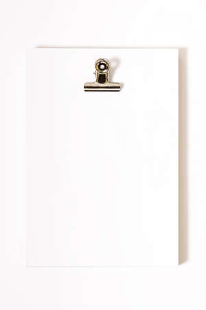 Studio photography of a packet of sheets of paper on a filing cabinet.Original photo to put advertising texts on white background.The photo is taken in vertical format.の写真素材