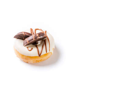 Photograph of a white chocolate donuts with dark chocolate cookies on a white background.の写真素材