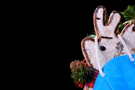 Photograph of a white cork Christmas ornament with a typical red bow and a blue hanging mask.の写真素材