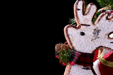 Photograph of a white cork Christmas ornament with a typical red bow. The photo is taken in studio on a black background and in horizontal format.の写真素材