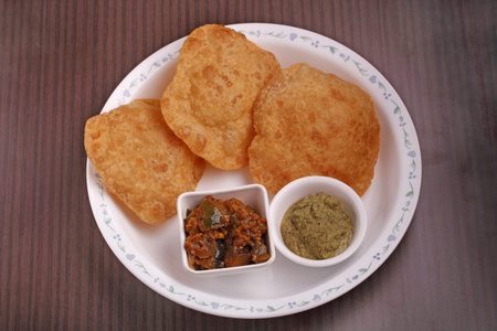 Indian deep-fried bread - poori with chutney and subzi