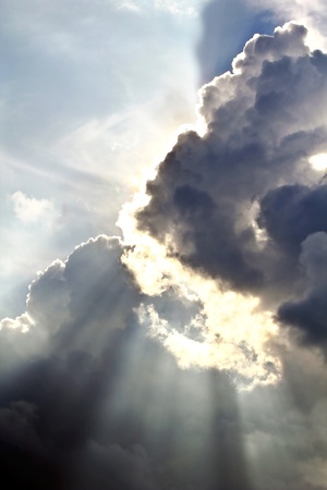 Spectacular sun rays emerging through the clouds の写真素材