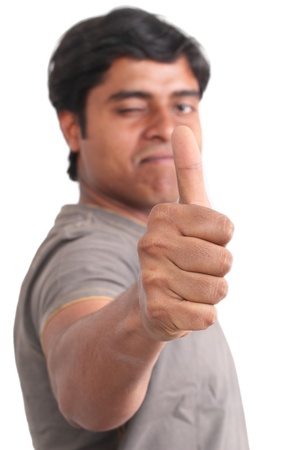 Portrait of happy young indian giving thumbs up over white background の写真素材