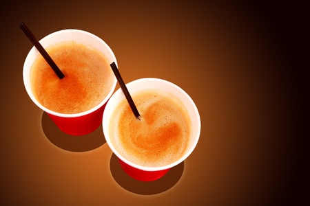 Two paper coffee cups filled with freshly brewed coffee served at a cafeの写真素材