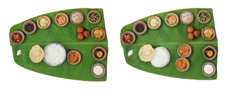 Sumptuous and wholesome onam meals called sadhya in kerala. The lunch contains varieties of curries and vegetable mixes along with papad, sweet appam and kheer. The food is served on a banana leafの写真素材