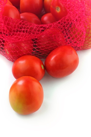 Fresh juicy organic tomatoes on white background. The fruits are ripe and bright red in color and ready for consumptionの写真素材