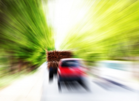 vehicles or automobiles moving at very high speed on a highway. The photo shows blurred cars & trucks as they are traveling fast on countryside roadの写真素材