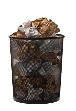 Filled up black metallic office trash basket isolated on whiteの写真素材