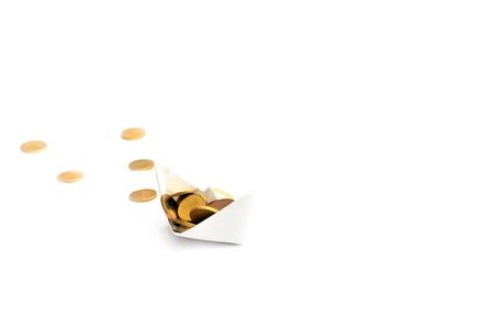 Paper ship carrying coinsの写真素材