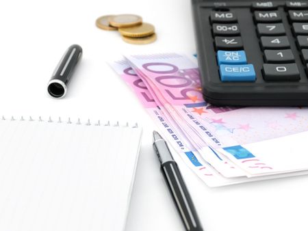 Blank notepad, pen, calculator and moneyの写真素材