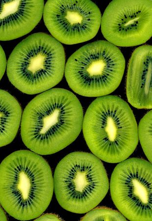 Abstract arrangement of sliced kiwi on black background. High resolution image.の写真素材