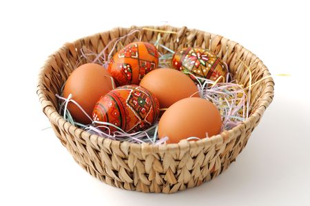 Painted and brown unpainted Easter eggs in the basketの写真素材