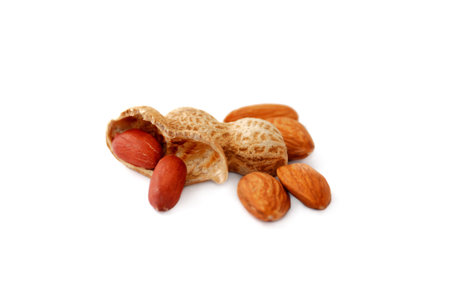 Almonds and peanuts isolated on white background