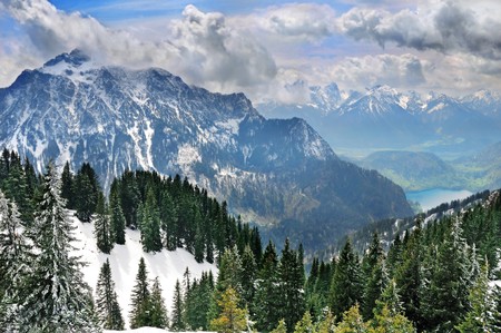Winter Alp mountains with lake in the valleyの写真素材