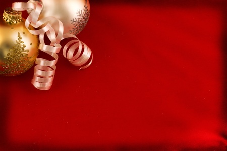 Christmas greeting card. Red textile background with decorative baubles and serpentine.の写真素材