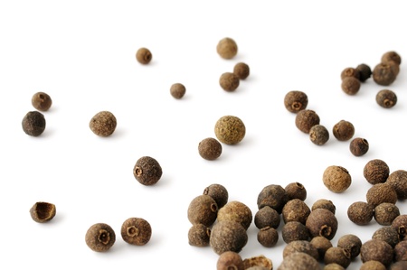 Allspice seeds artistically scattered over white backgroundの写真素材