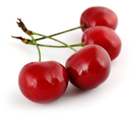 Fresh ripe cherries captured with low dof on white backgroundの写真素材