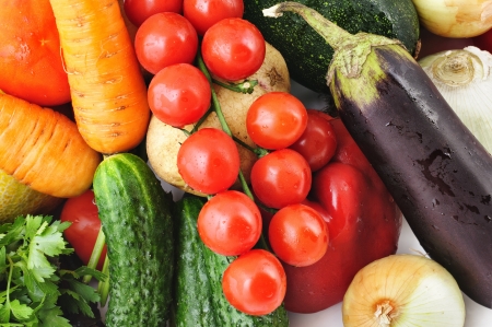 Fresh vegetables background with egg-plant, tomatoes, cucumber, potato, onion and carrotの写真素材