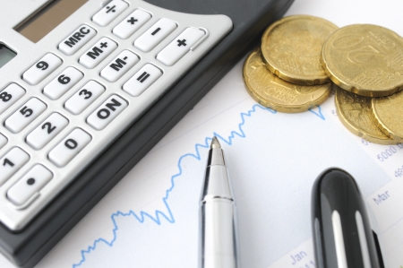 Finance background with coins, graph and calculatorの写真素材