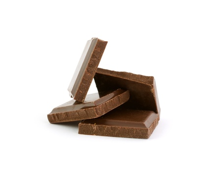 Heap of broken chocolate bars isolated on white backgroundの写真素材