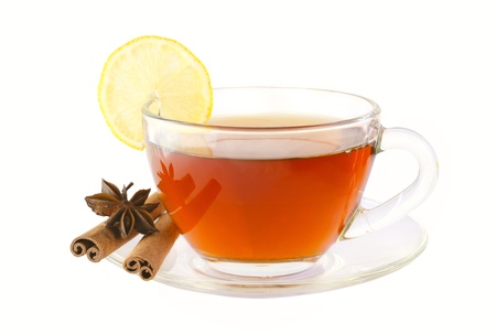 Delicious tea with spices and lemon in a glass cup isolated on whiteの写真素材