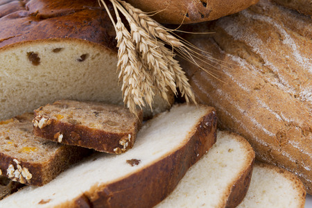 Various bread, cut and whole, and wheat ear. Backgroundの写真素材