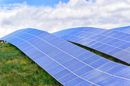 Solar energy panels with blue sky reflection