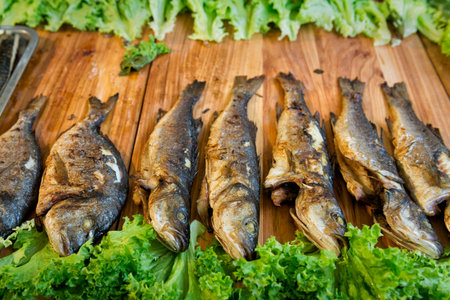 Fried fish on a wooden table in a street food fest