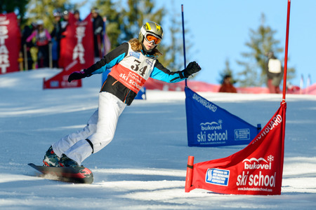 BUKOVEL, UKRAINE â DECEMBER 20, 2015: unidentified girl from snowboarding school training on the slope.のeditorial素材