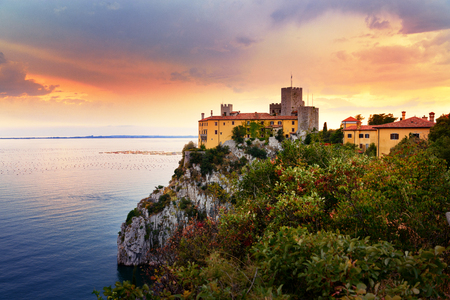Beautiful sunset sky over Duino Castle on the coast of Adriatic sea, Italyのeditorial素材
