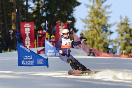 BUKOVEL, UKRAINE  DECMBER 20, 2015: unidentified girl competing in the amateur snowboarding competitionsのeditorial素材