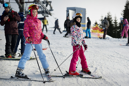 BUKOVEL, UKRAINE  DECEMBER 20, 2015: young girls skiers on a top of the slope. Bukovel is one of the best Ukrainian skiing resorts.のeditorial素材
