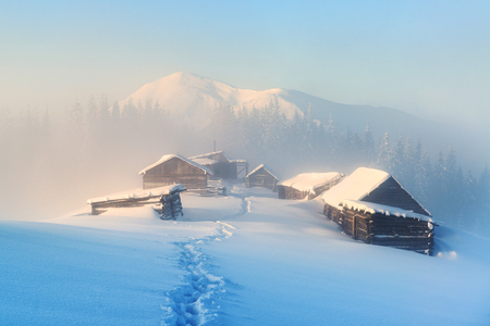 Beautiful winter scene high in the mountains with abandoned huts covered by snowの写真素材