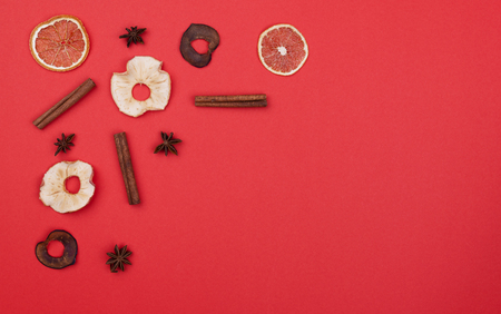 Mulled wine ingredients in the corner shape on red background. Free copy space for textの写真素材