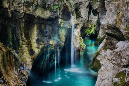 Beautiful scene with waterfalls in the gorge of Soca mountain riverの写真素材