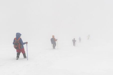 Tourist in the winter mountains lost their way in the fogの写真素材
