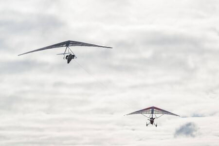 Motorized hang glider tows another wing. Hang glider aerotowingの写真素材