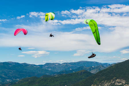 2014-07-30, Saint andre les alpes, France. Colorful paragliders fly above hill. Extreme sport in Franceのeditorial素材