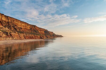 Colorful sand cliffs at the sea coast. Evening at the seaside near Odessa, Ukraineの写真素材