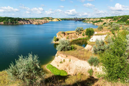 Flooded brown coal mine with big excavators in the water. Alexandriya, Ukraineの写真素材