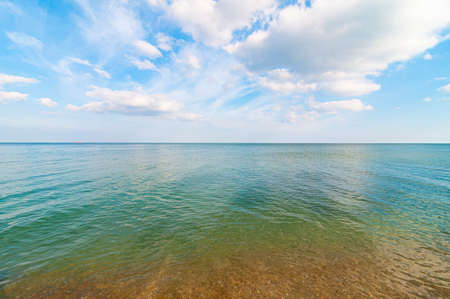 Endless sea and sunny sky with clouds. Seaside backgroundの写真素材
