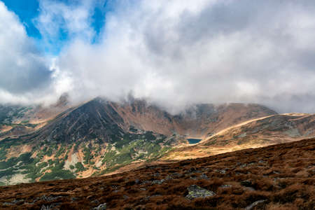 Dramatic clouds over glacial lake high in the mountainsの写真素材