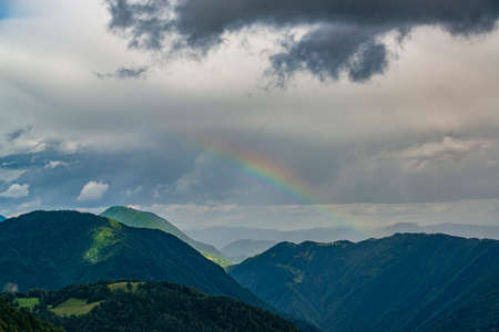 Rain and rainbow in the alps. Rainy weather in Soca valley, Slovenia.の写真素材