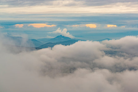 Mountain peaks and low clouds. Autumn weather in the Carpathian mountains.
