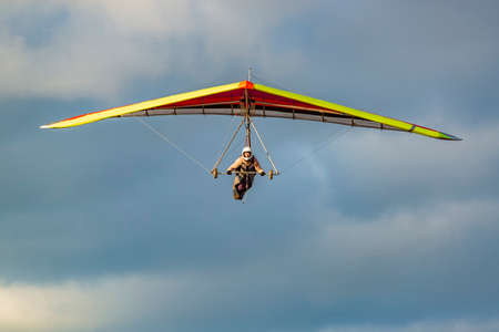 Beginner girl pilot withcolorful hang glider wing. Learning hang gliding. Extreme sports activityの写真素材