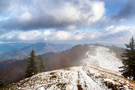 Mountain range covered with first winter snowの写真素材