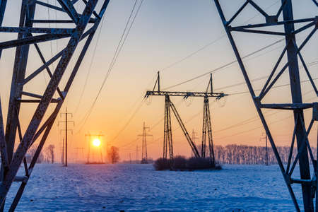 Power lines in the cold winter morning. Industrial landscape. Lack of energy in the wintertimeの写真素材
