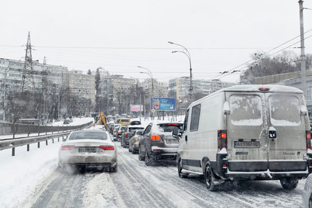 2021-02-09 Kyiv, Ukraine. Traffic jam during heavy snowfall. Bad weather forecast for drivingのeditorial素材