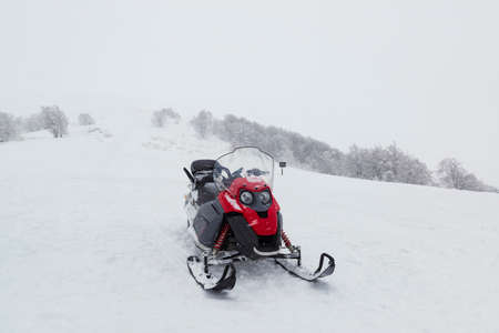 Snow mobile on the slope. Winter outdoor entertainmentの写真素材