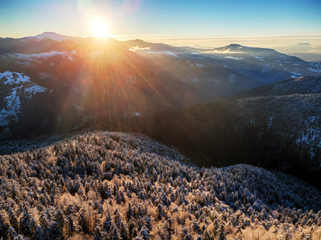Aerial panorama of beautiful sunrise in winter Carpathian mountainsの写真素材